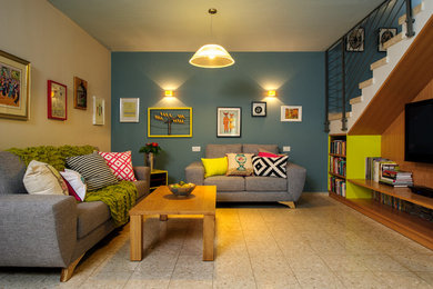 Example of an eclectic beige floor living room design in Tel Aviv with blue walls