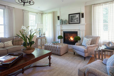 Inspiration for a large transitional formal medium tone wood floor and brown floor living room remodel in Boston with beige walls, a standard fireplace, a stone fireplace and no tv