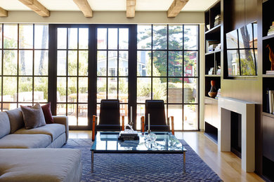 Example of a mid-sized trendy open concept light wood floor living room design in Los Angeles with white walls, a standard fireplace, a stone fireplace and a wall-mounted tv