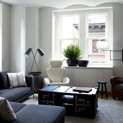 Example of a trendy living room design in New York with white walls