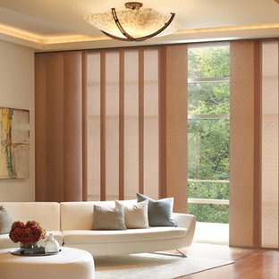 Example of a large trendy formal and enclosed medium tone wood floor and brown floor living room design in Orange County with beige walls and no tv