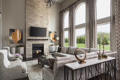 Example of a large transitional formal and open concept dark wood floor and beige floor living room design in Other with beige walls, a standard fireplace, a stone fireplace and a wall-mounted tv