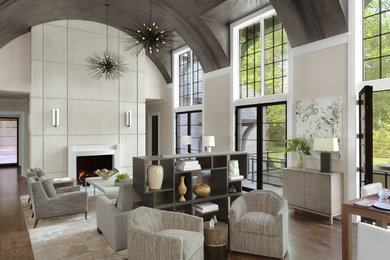 Foto de salón clásico renovado con paredes beige, suelo de madera en tonos medios, todas las chimeneas y suelo marrón