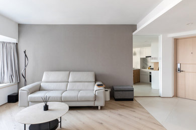 Living room - small modern open concept medium tone wood floor and brown floor living room idea in Hong Kong with multicolored walls and no fireplace