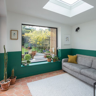 Photo of a scandinavian living room in West Midlands with multi-coloured walls and terracotta flooring.