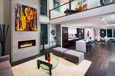 Photo of a large contemporary formal open plan living room in Calgary with dark hardwood flooring, a standard fireplace, no tv and grey walls.