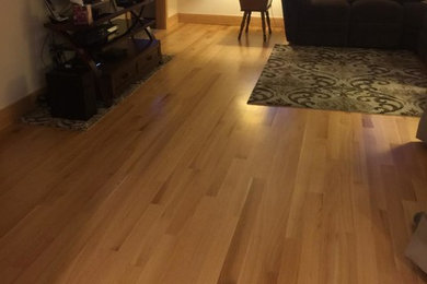 Example of a mid-sized classic open concept medium tone wood floor living room design in Burlington
