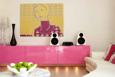 Inspiration for a mid-sized contemporary enclosed carpeted living room remodel in St Louis with a music area, pink walls and no tv
