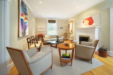 Example of a mid-sized trendy formal and enclosed light wood floor living room design in DC Metro with black walls, a two-sided fireplace and a brick fireplace