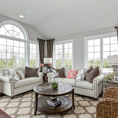 Transitional medium tone wood floor living room photo in Chicago with gray walls