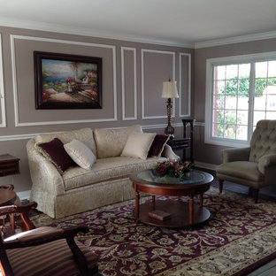 Living room - mid-sized traditional formal and enclosed laminate floor and brown floor living room idea in Orange County with gray walls