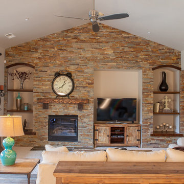 Interior remodel including flooring, stone wall, and lighting.
