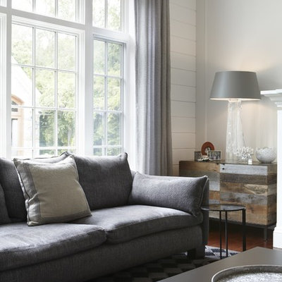 Living room - mid-sized transitional formal and enclosed dark wood floor living room idea in Toronto with white walls, a standard fireplace, a stone fireplace and no tv