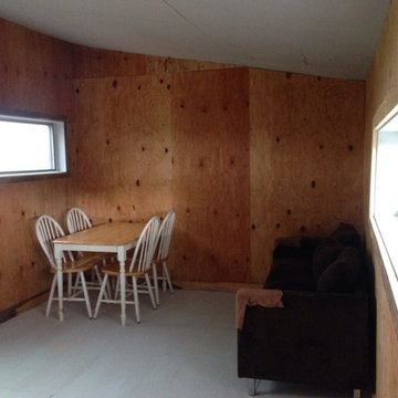 Interior with plywood walls, beetle kill trim, and white-wash plywood floors