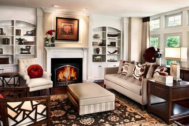 Living room - mid-sized formal and open concept medium tone wood floor living room idea in Boston with white walls, a standard fireplace and a wood fireplace surround