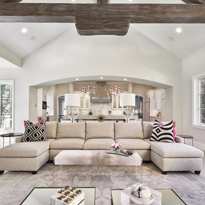 Huge transitional open concept medium tone wood floor living room photo in Austin with gray walls and a standard fireplace