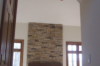 Foto de salón cerrado de tamaño medio con paredes blancas, todas las chimeneas y marco de chimenea de piedra