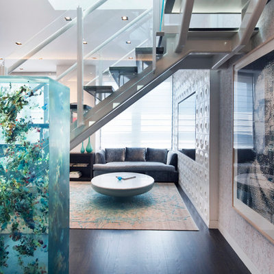 Inspiration for a contemporary open concept dark wood floor living room remodel in New York with a media wall