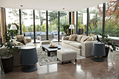 Photo of a contemporary formal living room in London with travertine flooring.