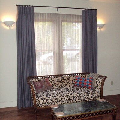 Example of a mid-sized classic formal and enclosed medium tone wood floor living room design in San Francisco with white walls and no tv
