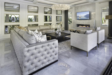 Example of a large trendy open concept marble floor and gray floor living room design in Orange County with white walls, a ribbon fireplace, a tile fireplace and a wall-mounted tv