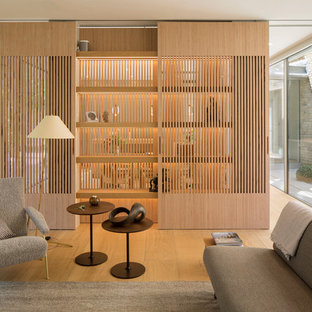 Photo of a modern open plan living room in London with white walls and light hardwood flooring.