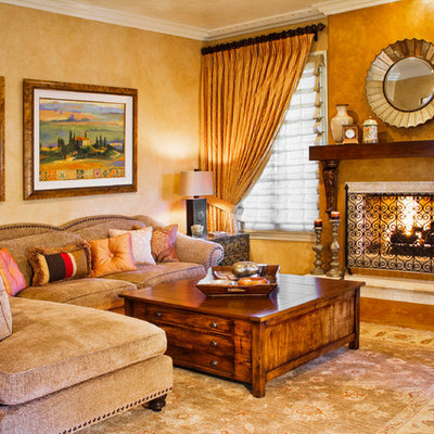 Inspiration for a mediterranean enclosed light wood floor and brown floor living room remodel in Los Angeles with a standard fireplace, beige walls, a plaster fireplace and no tv