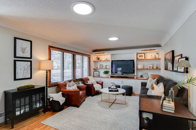 Inspiration for a small traditional open plan living room in Minneapolis with grey walls, light hardwood flooring, no fireplace and a built-in media unit.