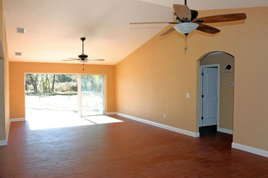 Inspiration for a large open concept medium tone wood floor living room remodel in Tampa with yellow walls