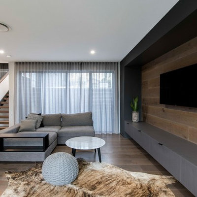 Living room - contemporary open concept medium tone wood floor and brown floor living room idea in Brisbane with white walls and a wall-mounted tv