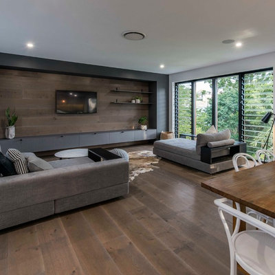 Living room - contemporary open concept medium tone wood floor and brown floor living room idea in Brisbane with white walls and a wall-mounted tv