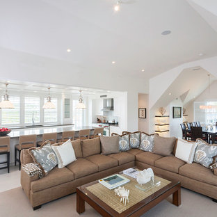 Large nautical open plan living room in Boston with white walls and no tv.