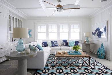 Example of a beach style gray floor living room design in New York with white walls