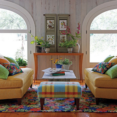 Example of a mid-sized trendy formal and enclosed medium tone wood floor and brown floor living room design in Boston with no tv, white walls and no fireplace