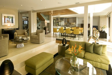 Example of a large trendy open concept beige floor living room design in Hawaii with beige walls and no fireplace