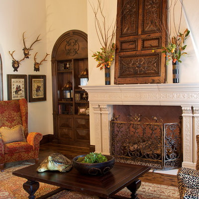 Inspiration for a mediterranean open concept medium tone wood floor living room remodel in Dallas with beige walls, a standard fireplace and a stone fireplace