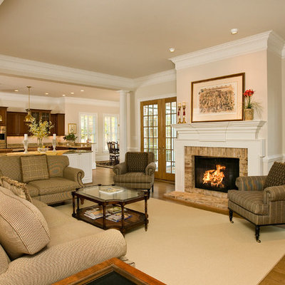 Inspiration for a timeless open concept medium tone wood floor living room remodel in Richmond with beige walls, a standard fireplace and a brick fireplace