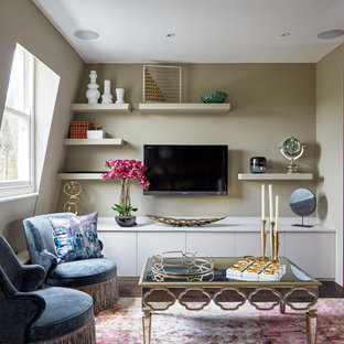 Inspiration for a small bohemian living room in London with green walls, dark hardwood flooring, a wall mounted tv, brown floors and no fireplace.
