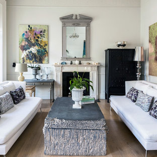 Inspiration for a medium sized classic formal enclosed living room in London with white walls, light hardwood flooring, a standard fireplace, a stone fireplace surround and beige floors.