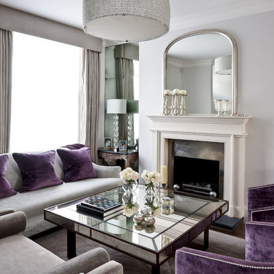 Large elegant open concept dark wood floor living room photo in London with white walls, a standard fireplace and a metal fireplace