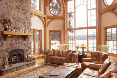 Example of a transitional open concept light wood floor living room design in New York with a standard fireplace and a stone fireplace