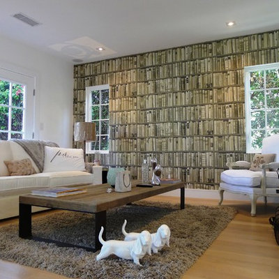 Example of a mid-sized eclectic enclosed light wood floor and beige floor living room library design in Los Angeles with a wall-mounted tv, beige walls and no fireplace