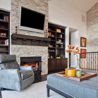 Inspiration for a mid-sized transitional loft-style dark wood floor and brown floor living room remodel in Seattle with a stone fireplace, white walls, a standard fireplace and a wall-mounted tv