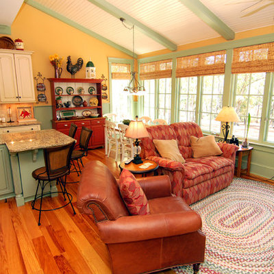 Inspiration for a mid-sized timeless open concept light wood floor and beige floor living room remodel in Raleigh with yellow walls and no tv