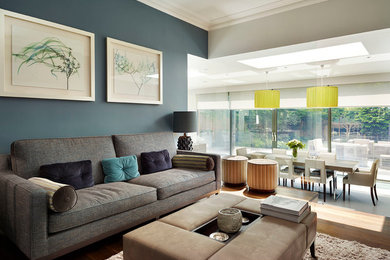 Photo of a contemporary grey and teal living room feature wall in London.