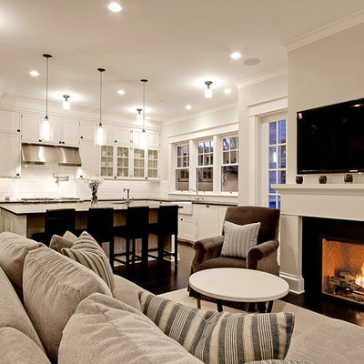 Example of a large classic open concept dark wood floor living room design in Seattle with white walls, a standard fireplace and a wall-mounted tv