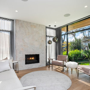 Design ideas for a large contemporary formal open concept living room in Sydney with white walls, medium hardwood floors, a standard fireplace and a stone fireplace surround.