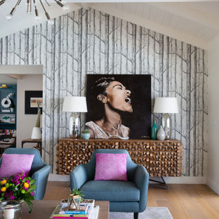 Example of an eclectic medium tone wood floor and brown floor living room design in Santa Barbara with multicolored walls