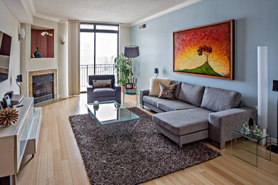 Example of a mid-sized minimalist formal and loft-style bamboo floor living room design in DC Metro with blue walls, a standard fireplace, a tile fireplace and a wall-mounted tv