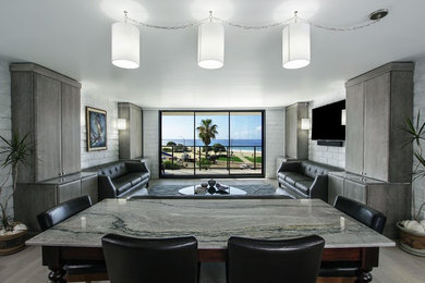 Modelo de salón abierto contemporáneo de tamaño medio sin chimenea con paredes blancas, suelo de madera clara y televisor colgado en la pared